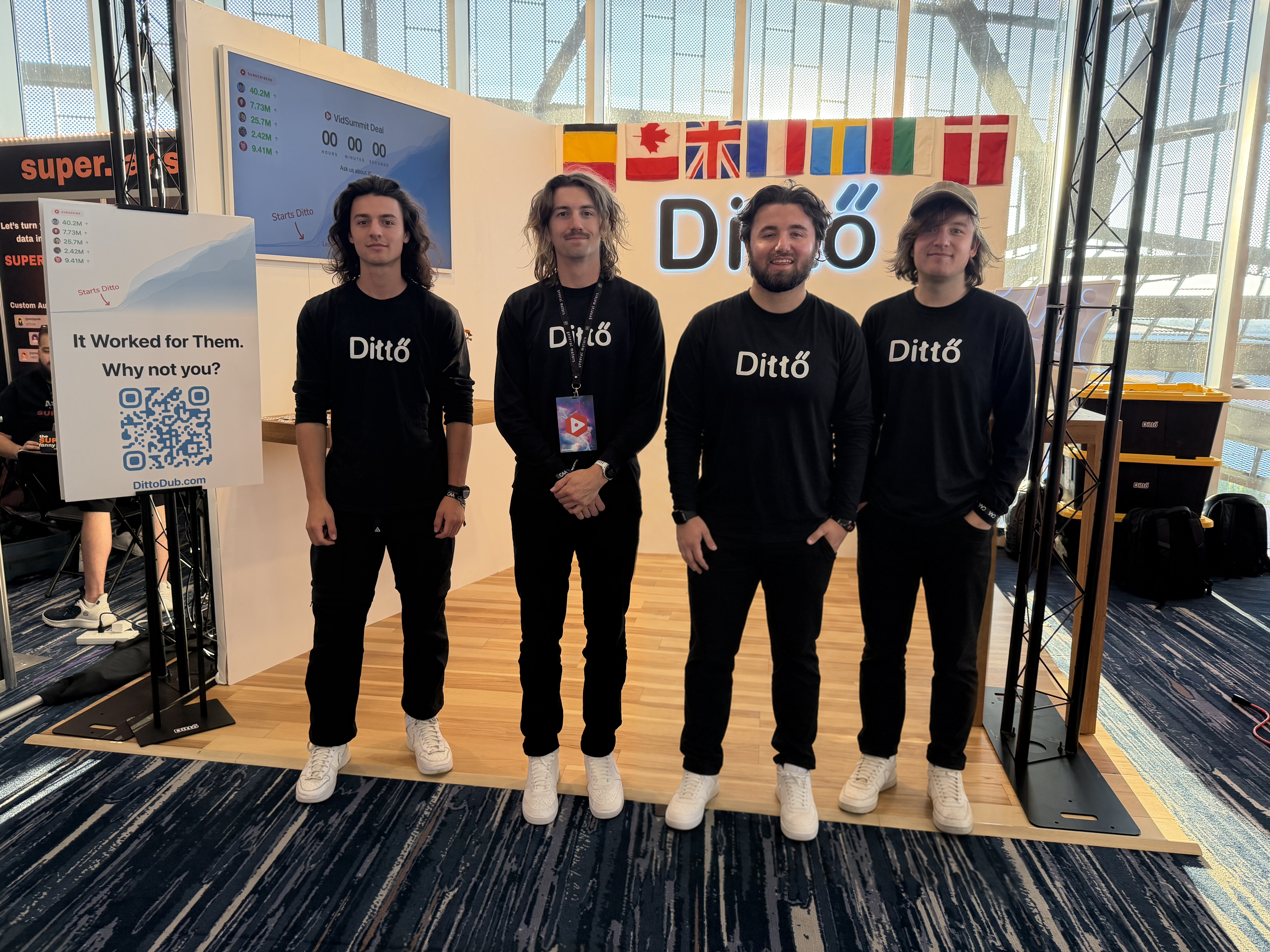 Four members of the DittoDub team standing in front of the DittoDub conference booth